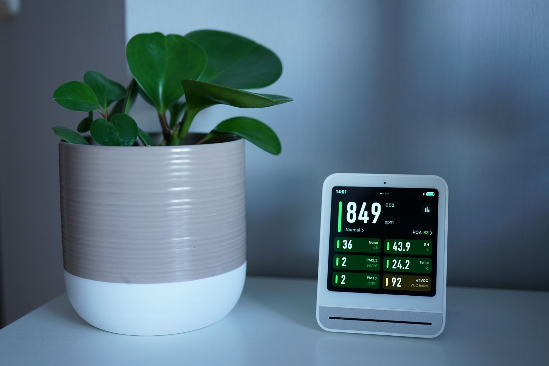 デスクの上でPM2.5やCO2の数値を表示している空気質モニターのイメージ